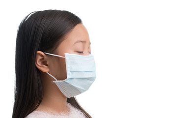Asian kid girl age 7 years with protection mask against flu virus