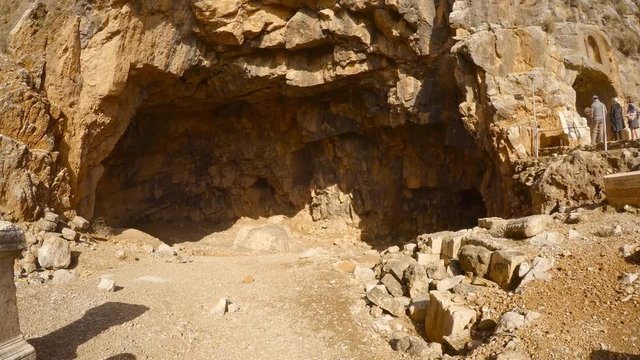 Tourists visit archaeological site of cave of Greek god pan, in Hermon Stream Nature Reserve, also known as Banyas, Golan, Israel