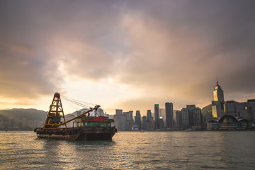 Fototapeta na wymiar Cargo ship floating at the HongKong harbour with sunrise background.