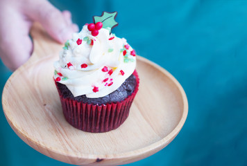 cupcake with christmas tree shape serving on wooden plate