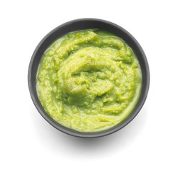 Tasty green sauce in bowl on white background