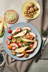 Delicious fresh salad with walnuts on plate