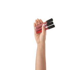 Woman holding lip glosses on white background