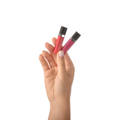 Woman holding lip glosses on white background