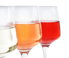 Glasses of tasty wine on white background, closeup