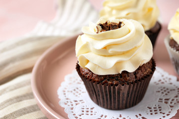 Tasty chocolate cupcake on plate, closeup