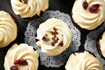 Tasty chocolate cupcakes on table