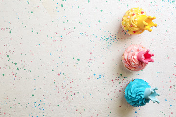 Tasty colorful cupcakes on light background