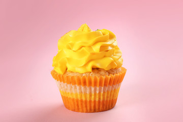 Tasty cupcake on color background