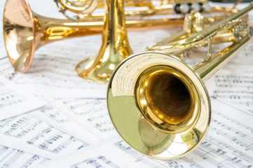 Three golden trumpet on sheet music