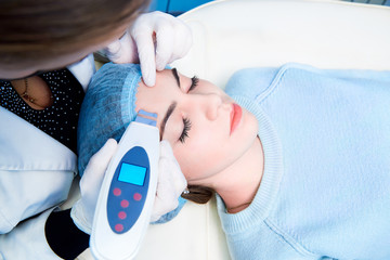 Procedure of ultrasonic cleaning of face. Ultrasonic scrubber.Concept of medical treatment and skin...
