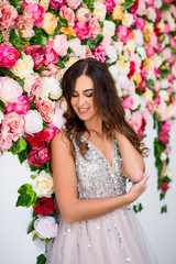 portrait of beautiful girl in dress over colorful flowers background