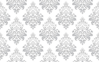 Floral pattern. Vintage wallpaper in the Baroque style. Seamless vector background. White and grey ornament for fabric, wallpaper, packaging. Ornate Damask flower ornament.