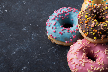 Glazed colorful donuts background with copyspace