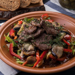 Grilled  veal  garnished with vegetables. Tasty meat salad with vegetables. Closeup