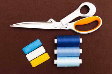 Sewing equipment on brown background.
