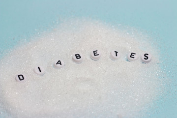 Inscription on sugar Diabetes, close-up, blue background, medical concept, Diabetes concept, World Diabetes Day.