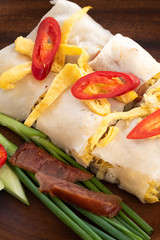 Thai Steamed Rice Noodle Rolls on wood background