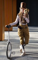 Pretty girl in a fantasy clothes with the mask and unicycle © Alexey Kuznetsov