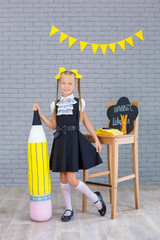 The schoolgirl in school uniform with books and textbooks is on a light gray background. Back to...