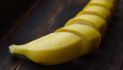 ripe bananas cut on a dark background