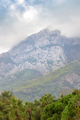 Rocky peaks of the Taurus Mountains during variable autumn weather, at the same time clouds and glimpses of the sun