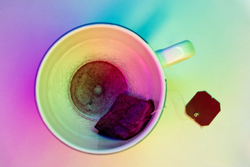 Empty cup of tea from top with colorful lighting