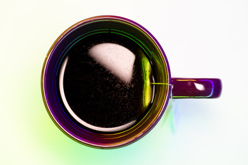 Filled cup of tea with tea bag from top