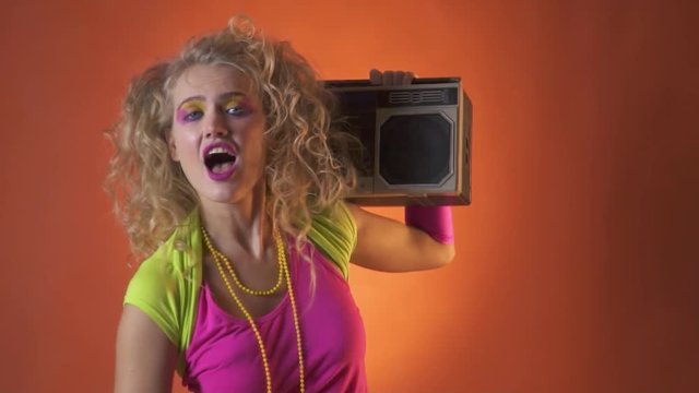 80s party girl dancing with the boombox on her shoulder