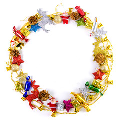 Christmas frame of decor balls, garland, beads, reindeer red pink blue golden decorations on white background. Top view.