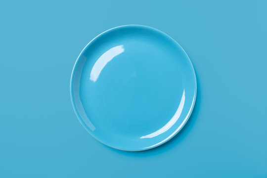 Blue pastel colored plate on blue background.