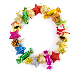 Christmas frame of decor balls, garland, beads, reindeer red pink blue golden decorations on white background. Top view.