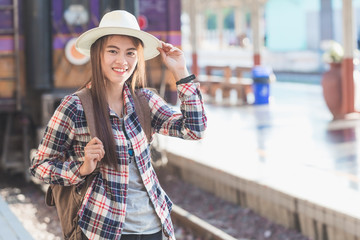 Beautiful young asian woman waiting for train at train station, Travel and vacation concept.  Chinese tourists.