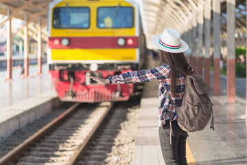 Beautiful young asian woman waiting for train at train station, Travel and vacation concept. ...