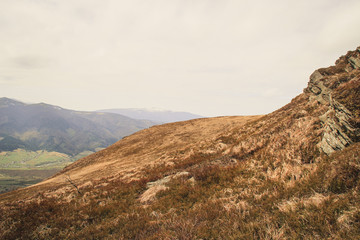 Ukrainian Carpathian Mountains. Autumn is coming. View from the top of the hill.