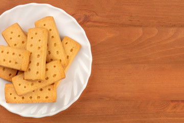 A closeup photo of Scottish shortbread butter cookies, shot from above on a rustic wooden background with copy space