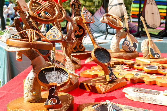 Kazakh national musical instruments handmade with horsehair strings for sale on a sunny day