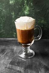 Irish coffee with whisky on dark background