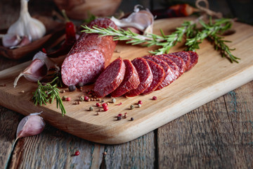 Smoked salami on a old wooden table.