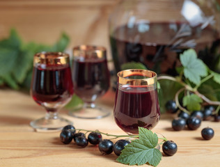 Homemade black currant liqueur and fresh berries .