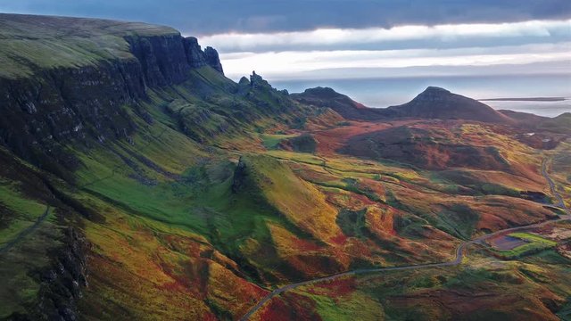 Cinematic flight over the Quiraing during sunrise on the eastern face of Meall na Suiramach, Isle of Skye, Highland, Scotland, UK