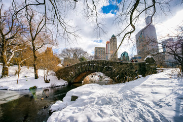 Snowy winter view of the scenic stone Gapstow Bridge in Central Park after a blizzard in New York City, USA