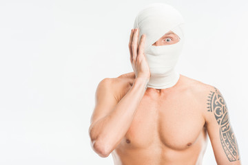 scared nude man with bandages over head after plastic surgery isolated on white