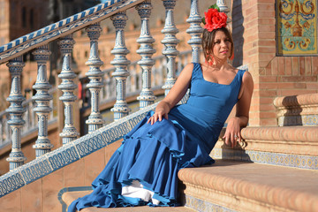 young woman with flamenco dress on the bridge
