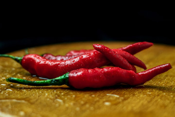 Isolated Fresh Red Chili Pepper on a Wooden Tray