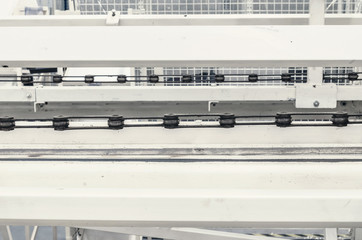 Large conveyor belt on a metal chain at a manufacturing plant