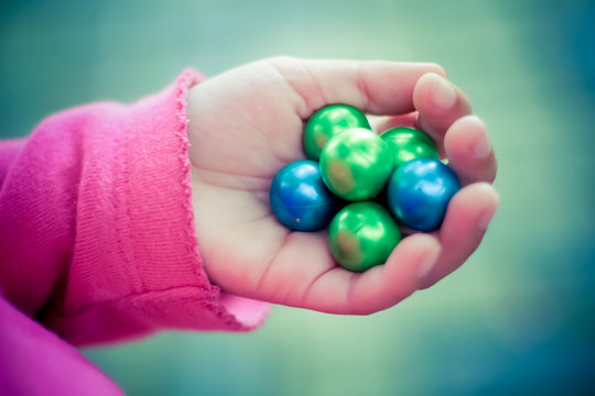 A Kid Holding Paintball Bullets
