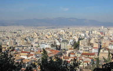 Athens from above with white buildings architecture, mountain, trees, blue sky in the morning hour in summer