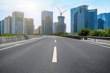 Fototapeta premium City skyscrapers and road asphalt pavement