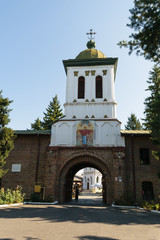 Fototapeta na wymiar Bucharest, Romania - August 10, 2017: Tourist visiting Plumbuita monastery in Bucharest, Romania - entrance and bell tower